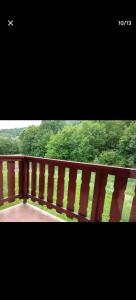 a wooden balcony with a view of trees at Studio Cabine, plein centre de Valloire in Valloire +3 photos