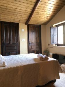 a bedroom with a large bed with towels on it at Casa Mediodía in Villanueva de los Caballeros