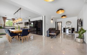 a dining room and living room with a table and chairs at 4 Bedroom Lovely Home In Labin in Labin