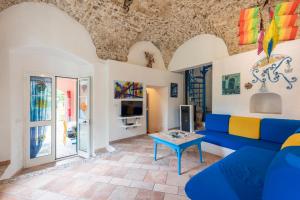 uma sala de estar com um sofá azul e uma mesa em Villa Sara - 5 Min From The Sea - Happy Rentals em Finale Ligure