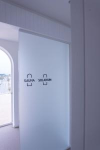 a white door in a room with a window at CALEA Boutique Hotel in Bacoli