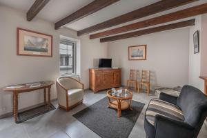 a living room with a couch and a table at À 400m des marais de Guérande - Maison de paludier in Kermoisan
