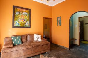 a living room with a couch and a painting on the wall at Ijaba Lodge at Buschfeld Park in Outjo