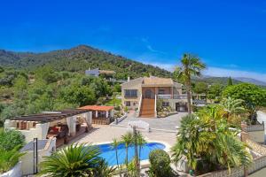 a house with a swimming pool in front of a mountain at Castillo Esmeralda in Alhaurín de la Torre