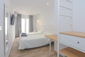 Postel nebo postele na pokoji v ubytování Hostal La Ermita