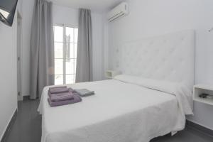 Postel nebo postele na pokoji v ubytování Hostal La Ermita