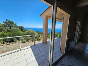 a balcony with a view of the ocean at Sari- Vue mer- climatisation in Sari Solenzara