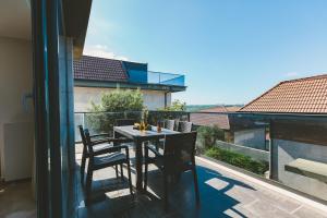 a table and chairs on the balcony of a house at Royal Blue Luxury Villas-İstanbul-Şile in Istanbul