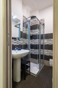 a bathroom with a sink and a shower at Casa Vacanze Nemesi AURA in Salerno +13 photos