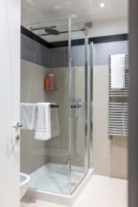 a bathroom with a shower with a glass door at Residence Prestige in Gorgonzola