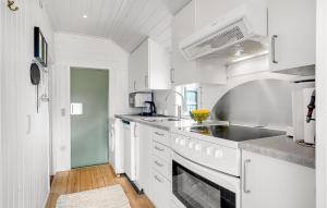 a white kitchen with a sink and a stove at Stunning Home In Fanø With Kitchen in Fanø