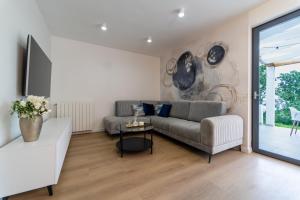 a living room with a couch and a table at Villa Mare&Monti in Opatija, Heated pool with sea view in Opatija