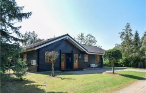 a log cabin with a yard at Three-Bedroom Holiday Home In Oksbol in Oksbøl +18 photos