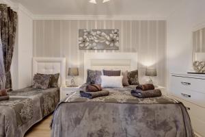a bedroom with two beds and a painting on the wall at Castillo Esmeralda in Alhaurín de la Torre +54 photos