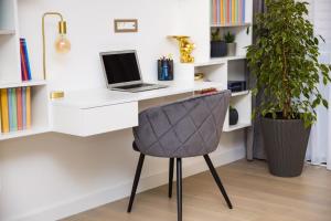 a desk with a laptop and a chair in a room at Villa Perla in Tivat