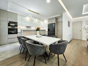 a kitchen with a white table and chairs at Villa Perla in Tivat