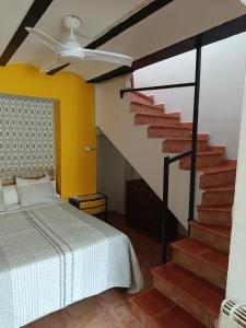 a bedroom with a bed and a staircase at Casa en el centro del pueblo de Finestrat in Finestrat