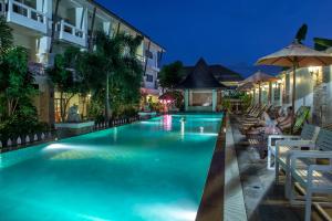 a swimming pool in a hotel at night at Neptune's Villa in Haad Rin