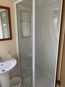 a bathroom with a shower and a sink at 29 Morningside at Southview in Skegness - Park Dean resorts in Lincolnshire