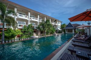 a swimming pool in front of a hotel at Neptune's Villa in Haad Rin
