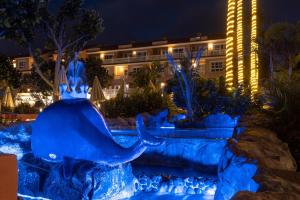 an elephant fountain in front of a hotel at night at Hotel El Duque in Adeje