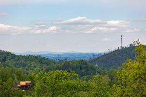 a house on top of a hill with trees at Peace Giver by Eden Crest in Gatlinburg