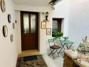 a hallway with a door and a table and chairs at T4House in Sighişoara