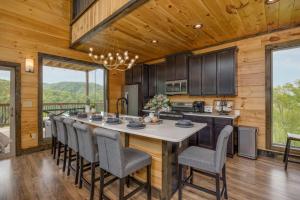 a kitchen with a large island with bar chairs at Peace Giver by Eden Crest in Gatlinburg