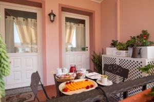 a table with a plate of food on top of it at B&B L'Asfodelo in Villa San Pietro