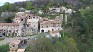 an old village on a hill with buildings at Mas d'Aval in Le Vigan