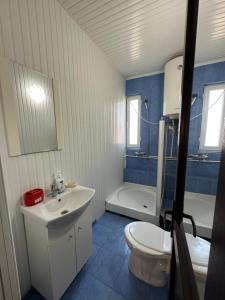 a bathroom with a white sink and a toilet at Casa Anda in Mangalia