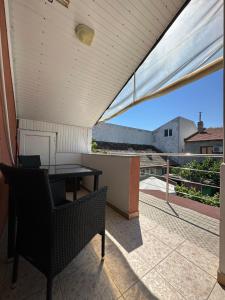 a patio with a table and chairs on a balcony at Casa Anda in Mangalia