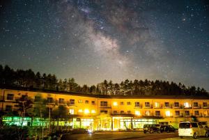 a building with the milky way in the sky at Yatsugatake Grace Hotel in Minamimaki