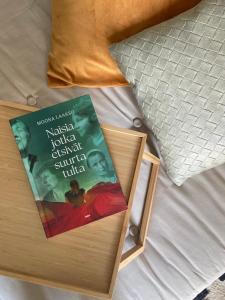 um livro sentado em cima de uma cama em Viihtyisä yksiö, oma parkkipaikka, wifi, Aino Areena 300m em Järvenpää