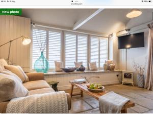a living room with a couch and a table at The Old Candle Shop in Little Walsingham