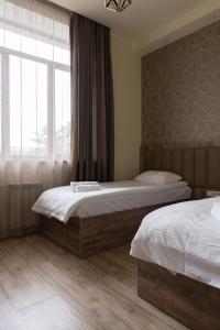 Postel nebo postele na pokoji v ubytování Glendale Boutique Hotel