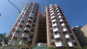 two tall apartment buildings against a blue sky at Apê com churrasqueira guilhermina in Praia Grande