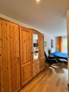 a bedroom with wooden cabinets and a bed and a room at Obm See in Davos Wolfgang
