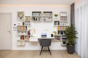 a desk in a room with white shelves at Villa Perla in Tivat