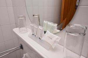 a bathroom counter with a mirror and a sink at Aristotelis Hotel in Stavros