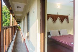 a small bedroom with a bed in a building at Kailash Guest House in Puducherry
