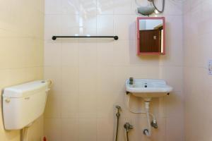 a bathroom with a toilet and a sink at Kailash Guest House in Puducherry