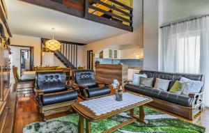 a living room with leather furniture and a table at Apartment Fucane Iv in Medulin