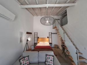 a bedroom with a bed and a stair case at Cercas Velhas in Sagres