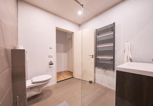 a bathroom with a toilet and a sink at The Suite Eindhoven by T&S in Eindhoven