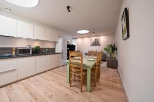 a kitchen and dining room with a table and chairs at The Suite Eindhoven by T&S in Eindhoven