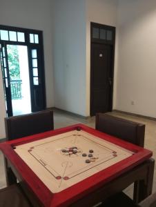 a table with a clock on top of it at Nade Villas Ahungalla in Ahungalla