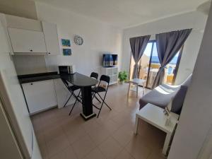 a kitchen and living room with a table and chairs at Apartamento con maravillosas vistas en primera línea in La Restinga +8 photos