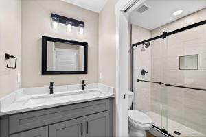 a bathroom with a sink and a toilet and a shower at The Bay House-Bayfront serenity, stunning sunsets in Ward Ridge +17 photos