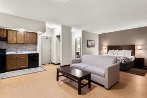 a living room with a bed and a couch at Red Roof Inn Norwich in Norwich